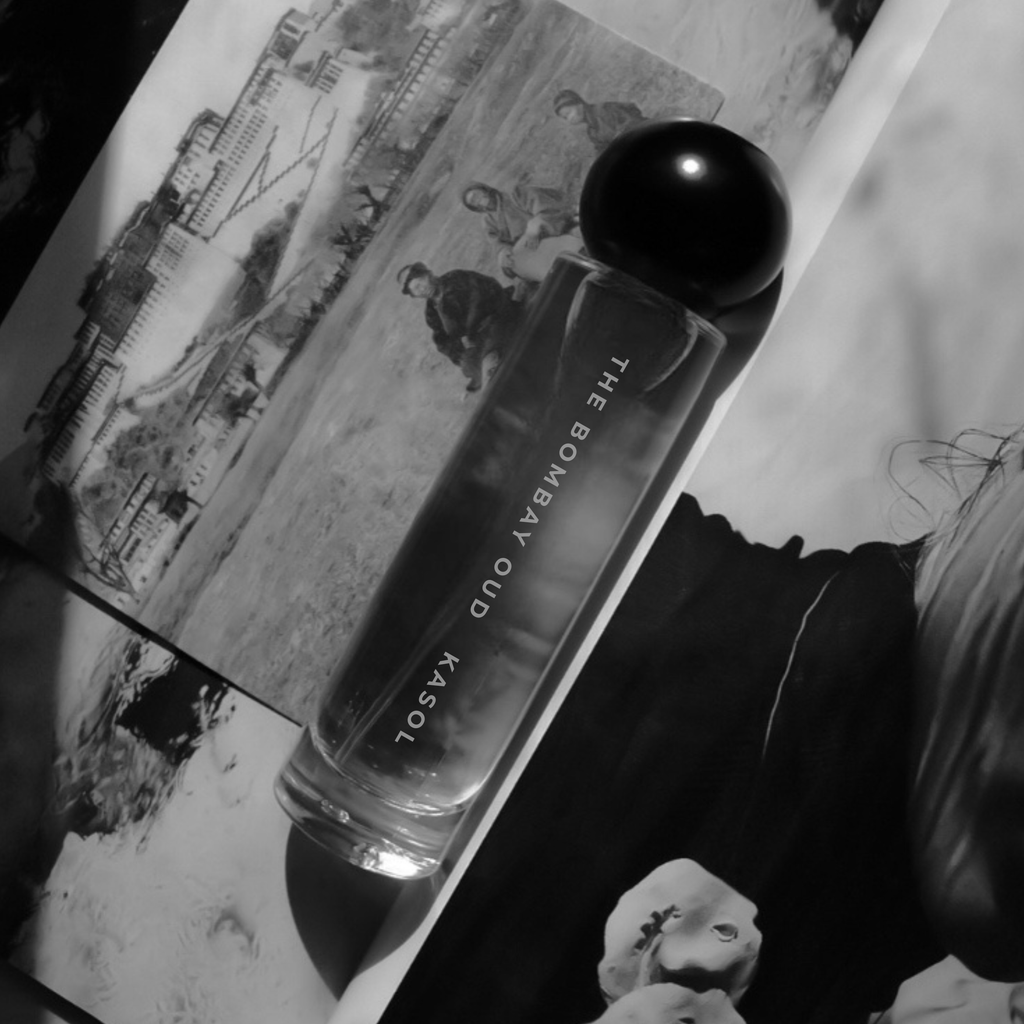 Kasol 60ml fragrance bottle in monochrome, placed on vintage-style photographs, highlighting its nostalgic and artistic appeal.
