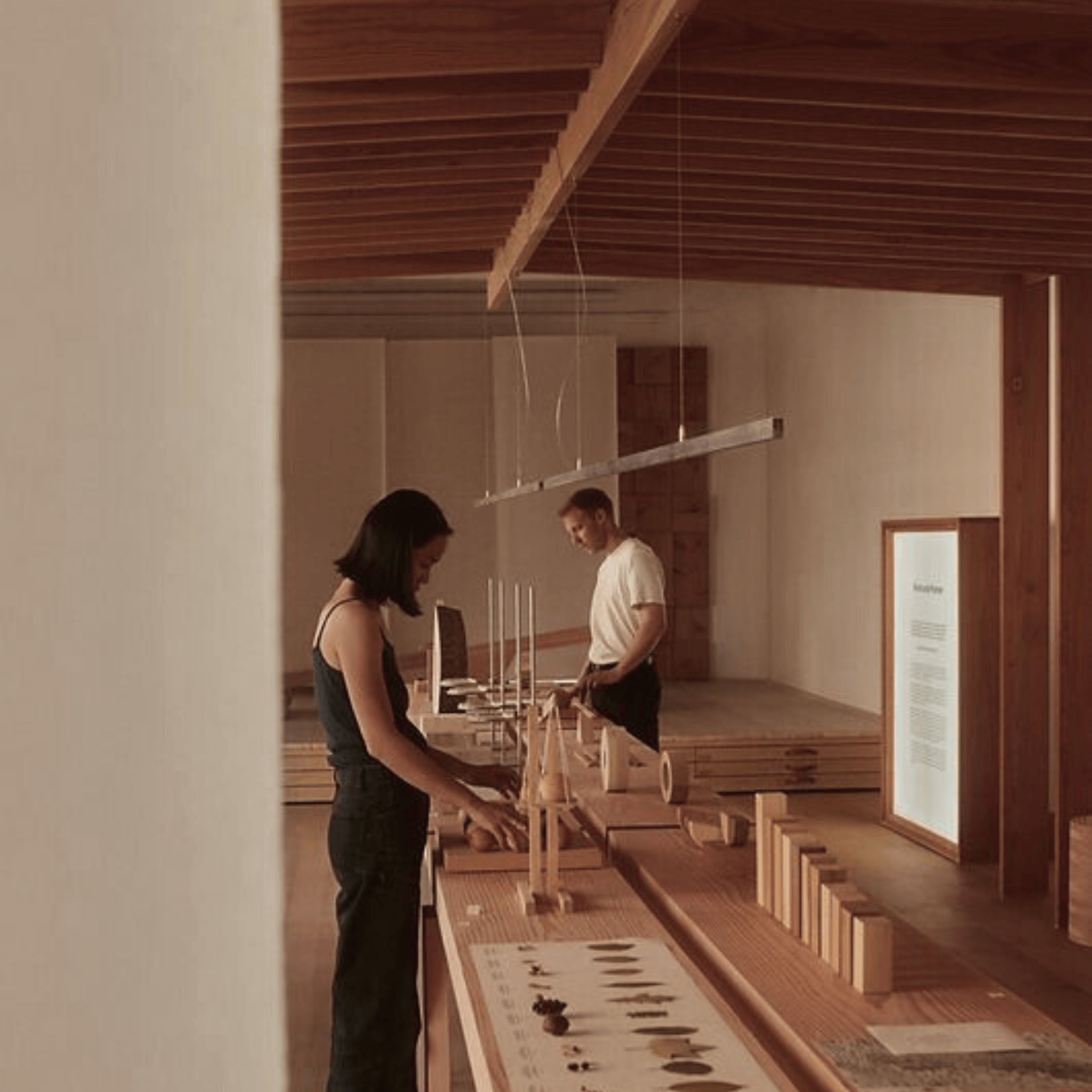 Visitors exploring a minimalist fragrance exhibit, featuring Kasol 60ml’s natural ingredients and artisanal perfume process.