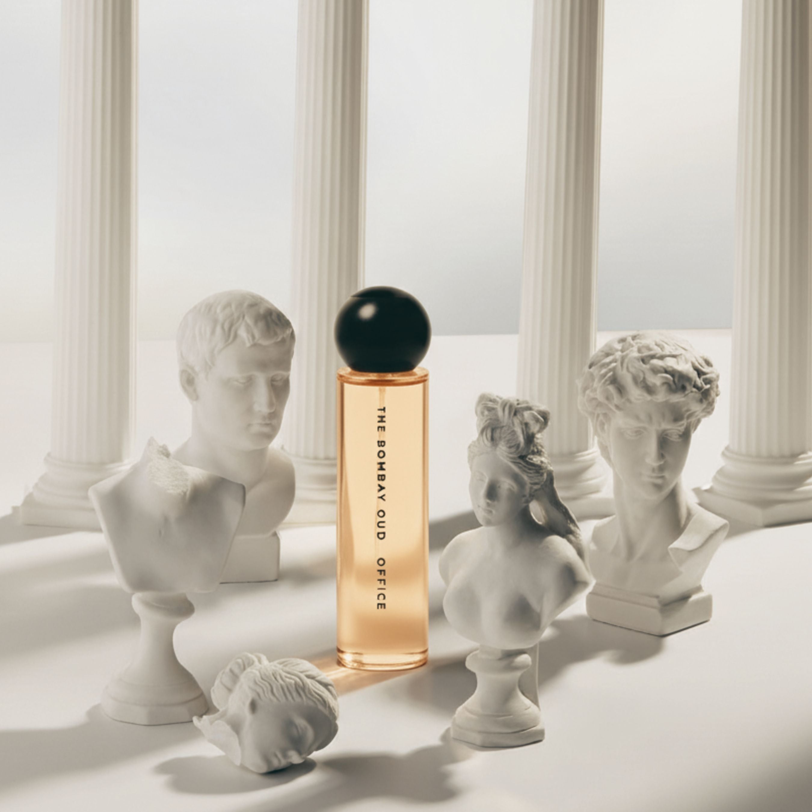 Office 60ml by The Bombay Oud surrounded by classical sculptures, reflecting timeless elegance and artistic sophistication.