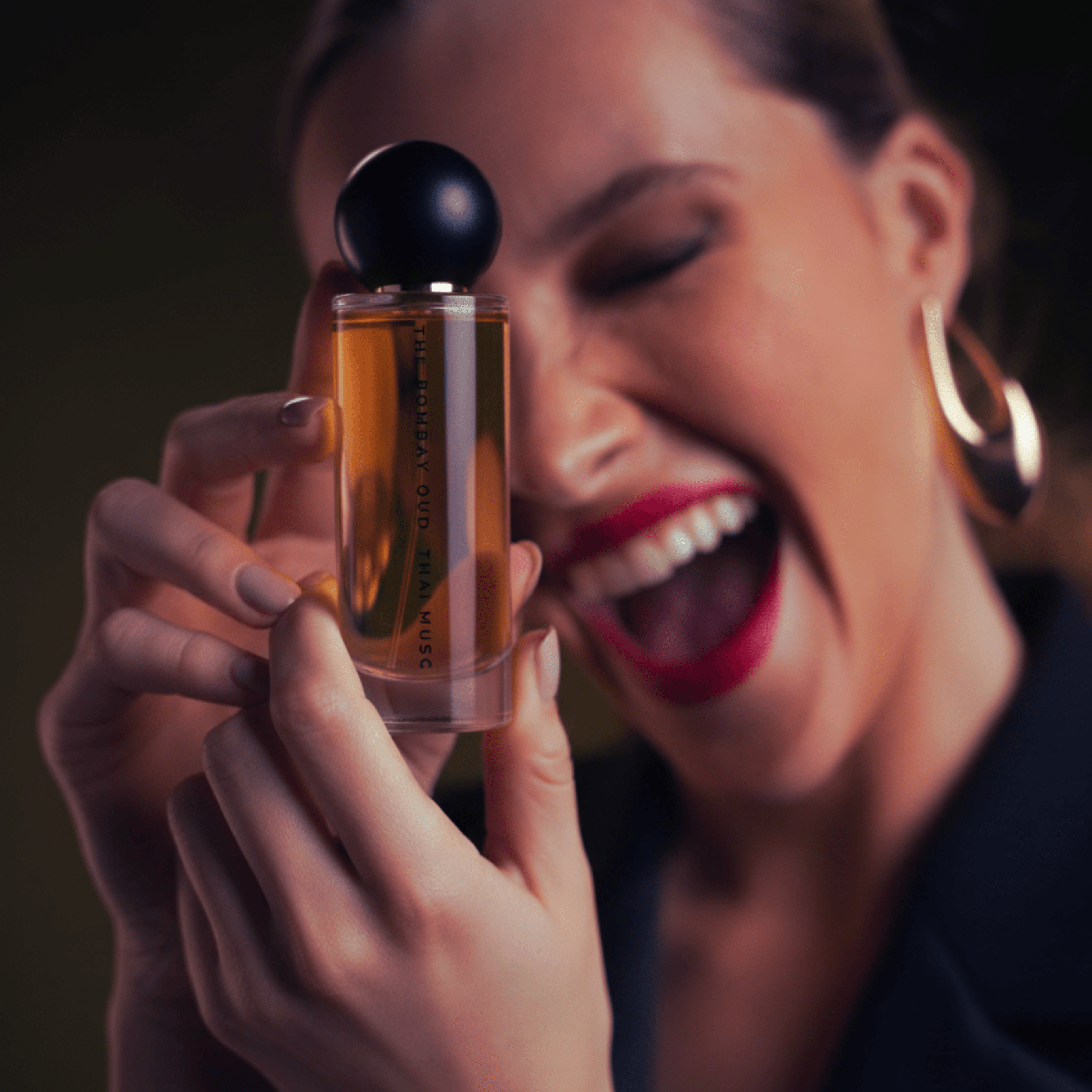 Woman joyfully holding Thai Musc 60ml perfume, showcasing its elegant design and appeal in the personal care fragrance category.