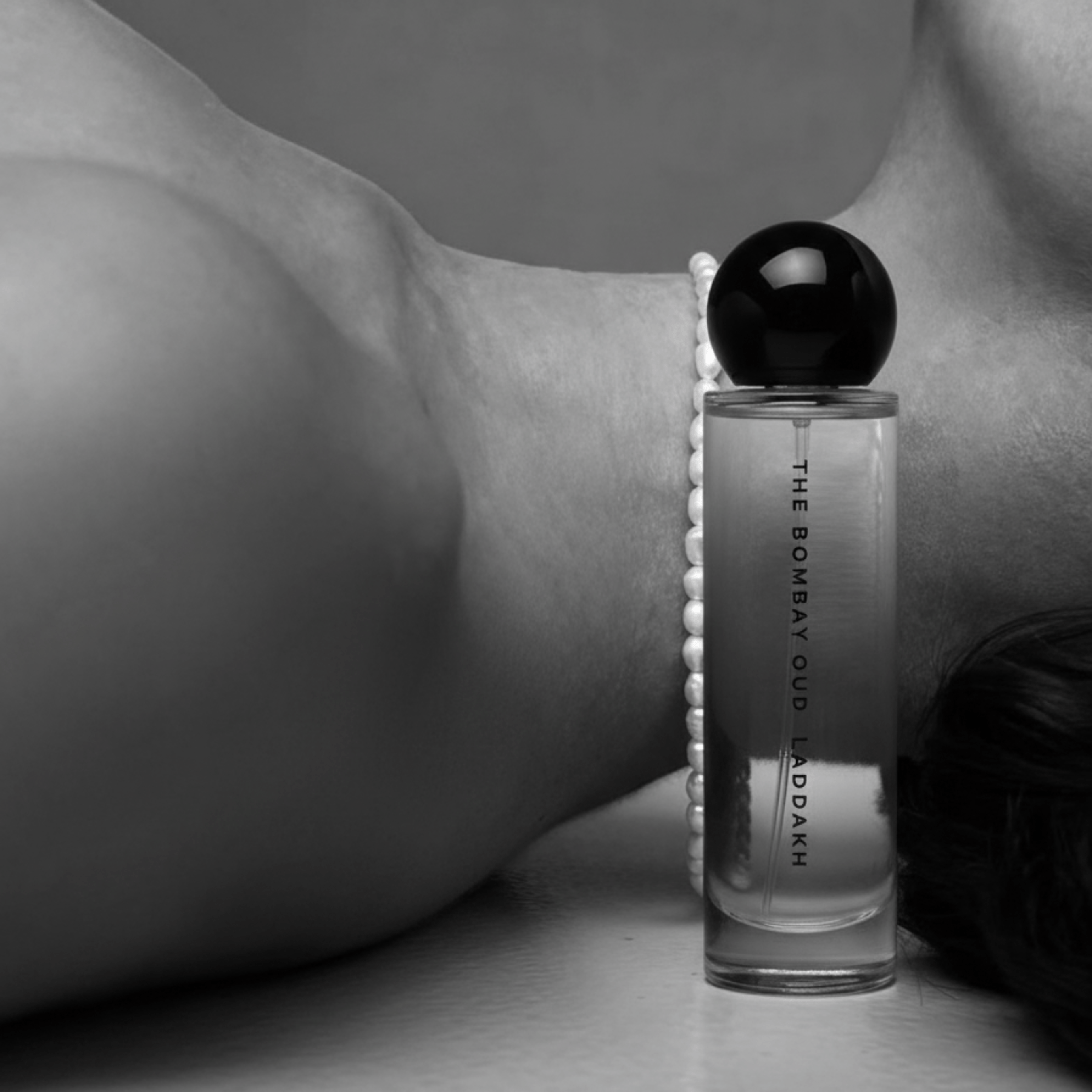 Laddakh 60ml perfume bottle resting beside a woman's neck, emphasizing its sensual and luxurious appeal in the personal care category.