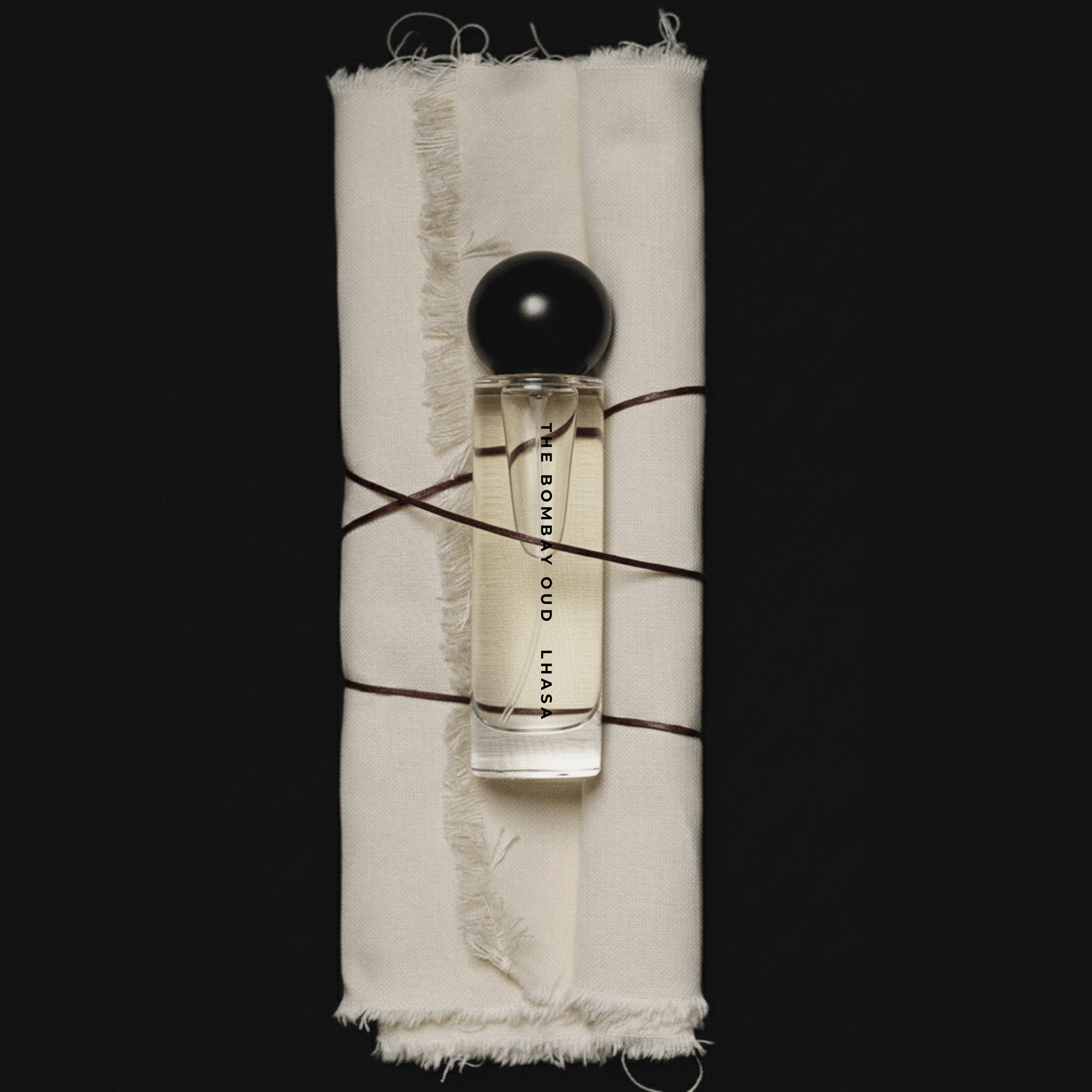Lhasa 60ml perfume by The Bombay Oud in a sleek glass bottle with a black spherical cap, ideal for luxury fragrance lovers seeking mystique.