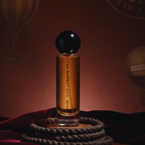 Boond 60ml perfume bottle displayed on velvet with rope and hot air balloon backdrop, evoking its warm Kashmiri Oud and amber fragrance notes.