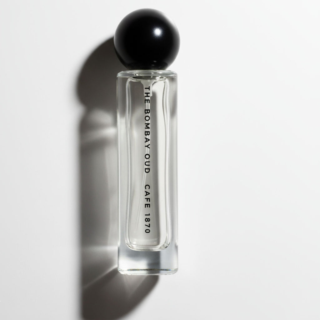 Cafe 1870 60ml perfume bottle by The Bombay Oud with minimalist design and black spherical cap, ideal for personal fragrance collections.
