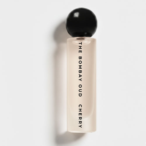 Cherry 60ml perfume by The Bombay Oud in a sleek frosted bottle with black spherical cap, ideal for a sensual and warm fragrance experience.