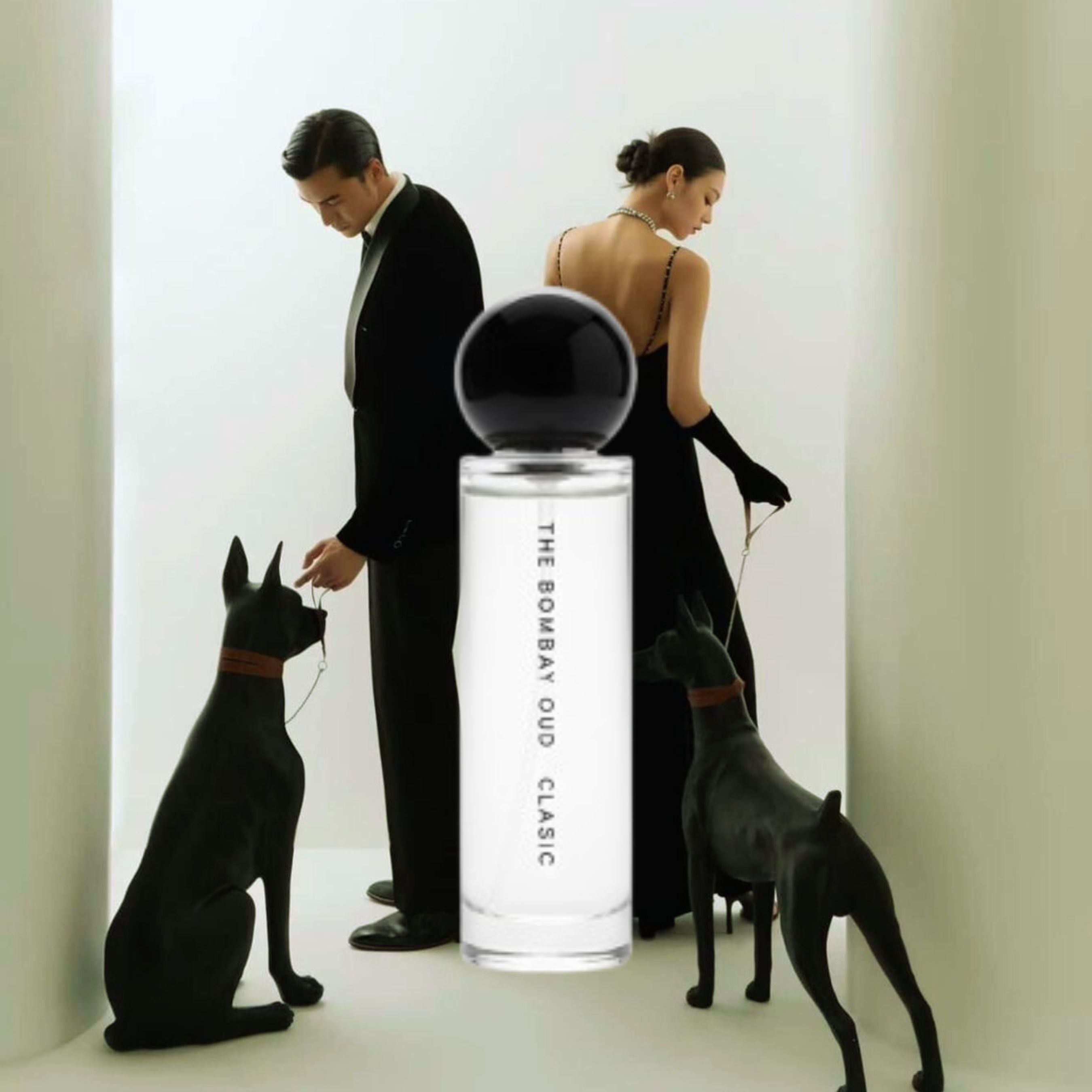 Classic 60ml perfume by The Bombay Oud showcased with a stylish couple and black dogs, reflecting elegance and sophistication in personal care.
