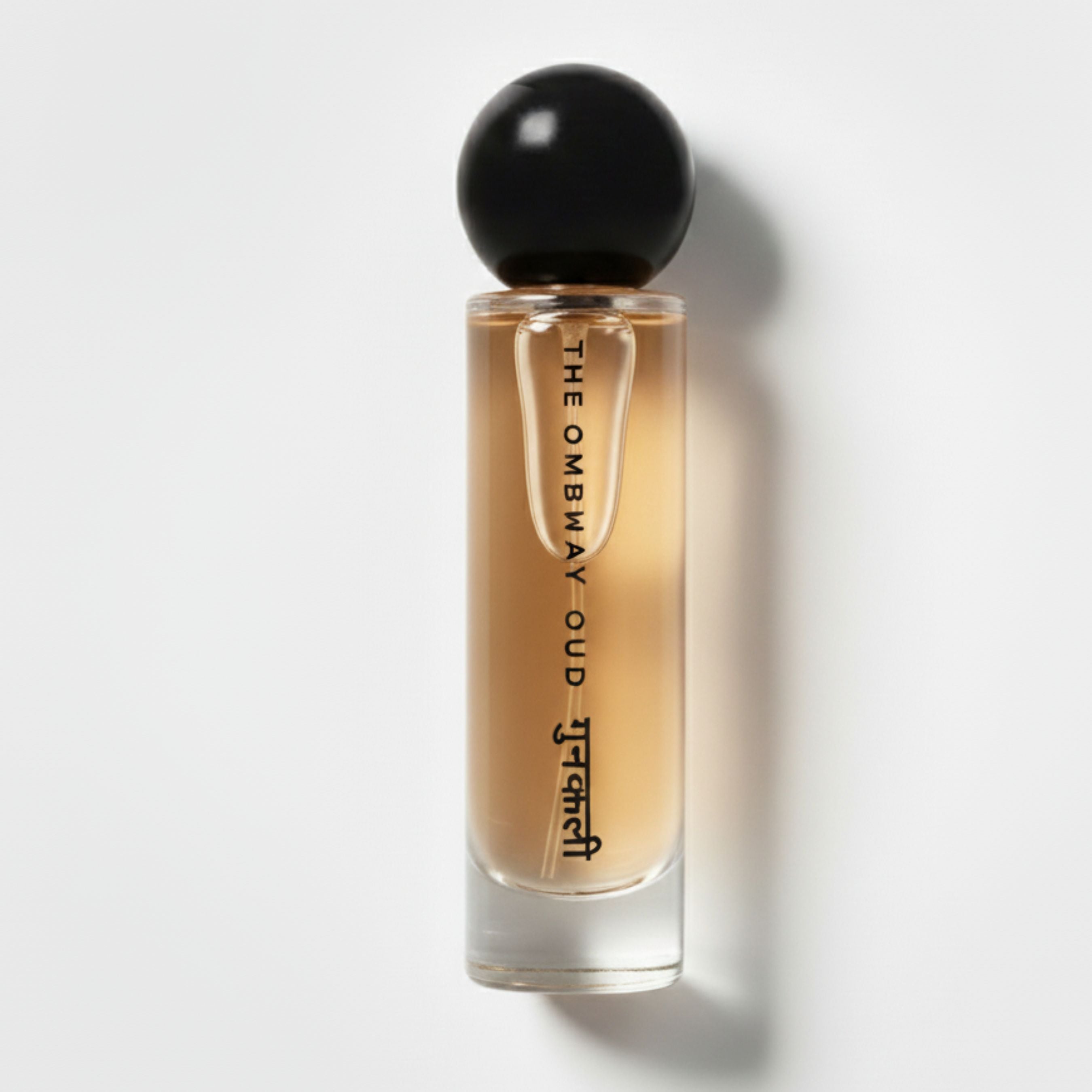 Gunkali 60ml luxury perfume bottle with black spherical cap and elegant amber liquid, part of The Bombay Oud collection for personal care.
