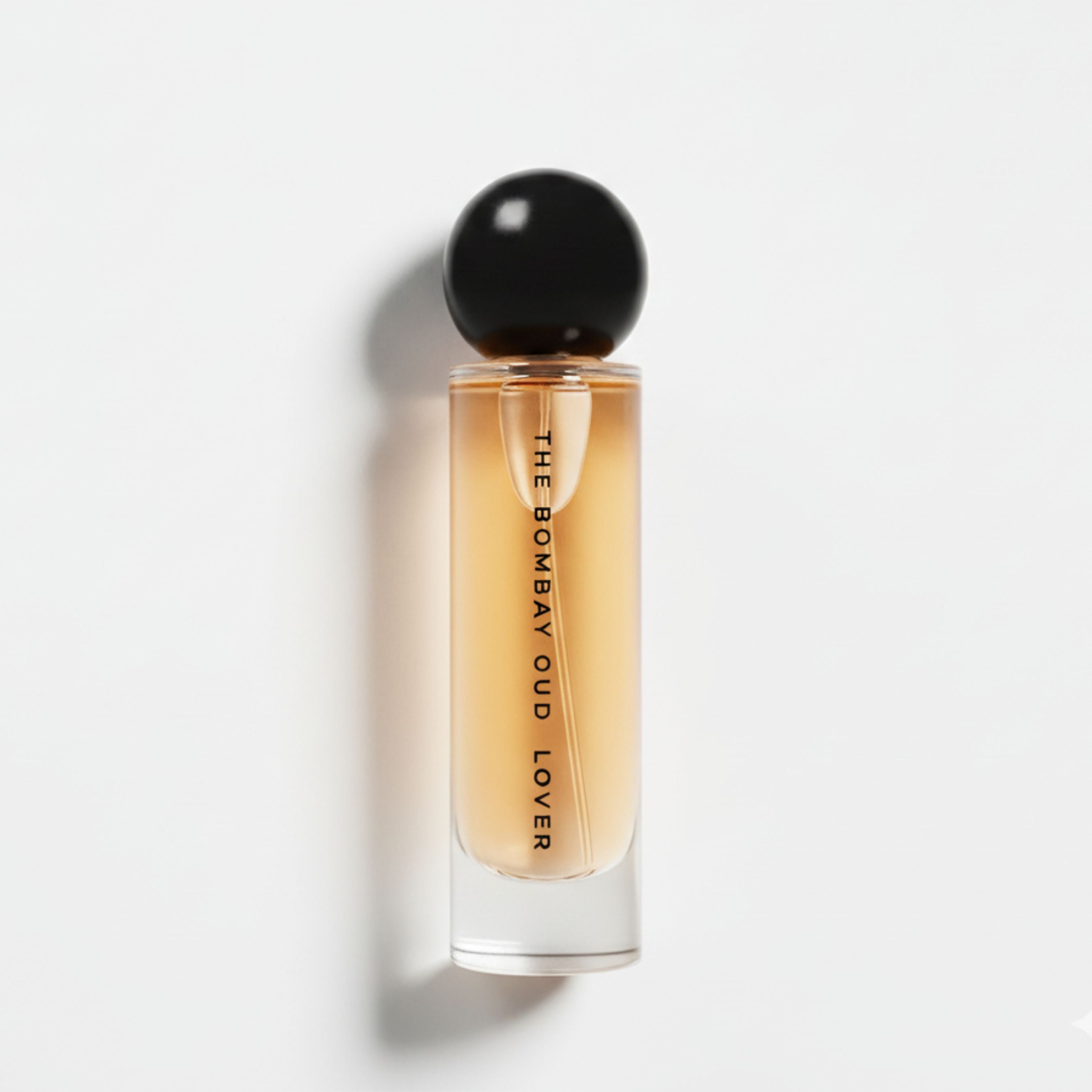 Lover 60ml eau de parfum by The Bombay Oud in a sleek glass bottle with black spherical cap, ideal for luxury fragrance lovers.