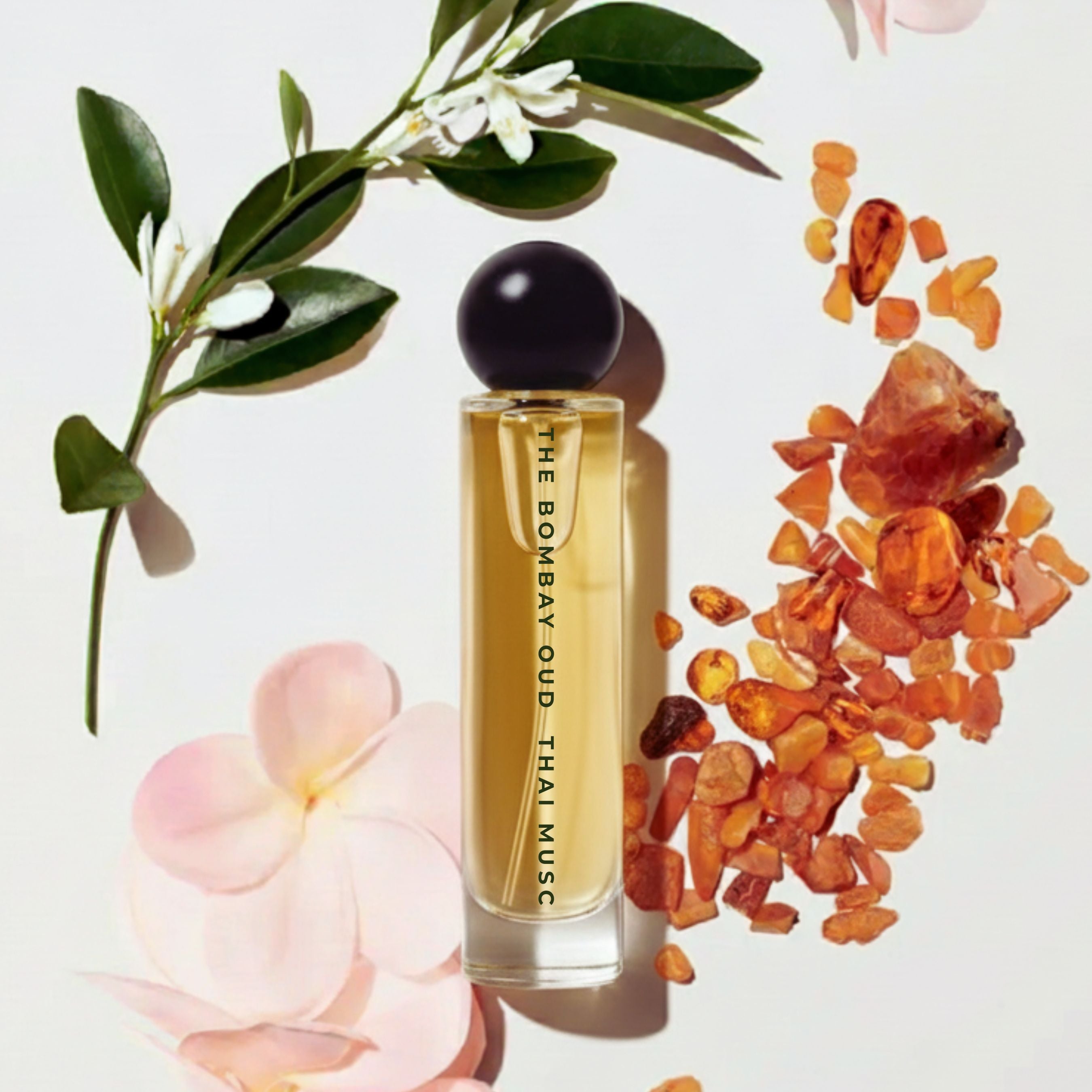 Thai Musc 60ml perfume bottle styled with amber resin, white florals, and pink petals, highlighting its musky floral scent profile.